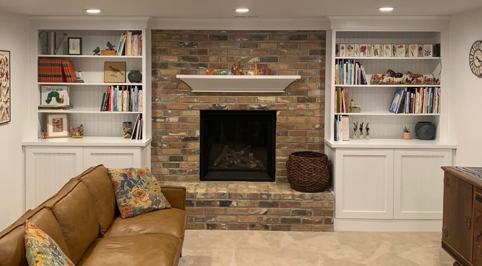 Living room with brick fireplace and bookshelves, cabinet in soothing blue color, invoking calmness and tranquility